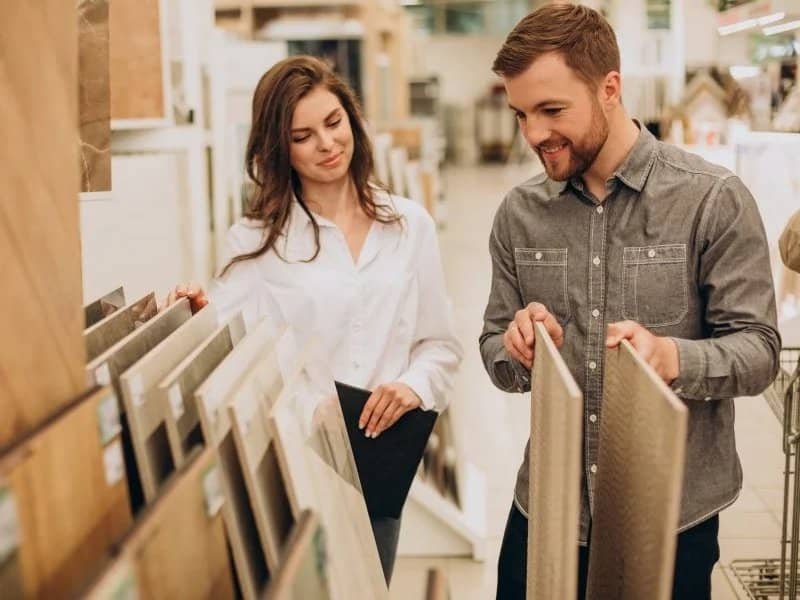 young couple looking at flooring samples | Northern Colorado | 970-352-7251 |