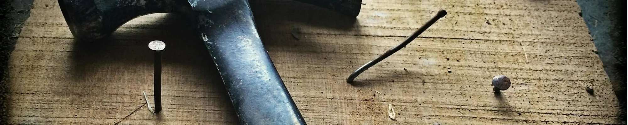 hammer and nails on wooden table| Northern Colorado | 970-352-7251 |