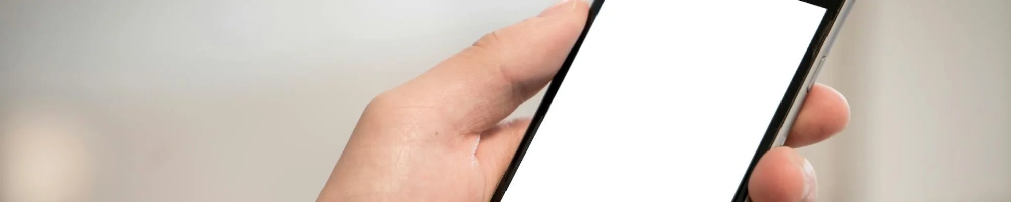 person hold a cell phone in their hand | Mitchell's Flooring & Design | Serving Northern Colorado | 970-352-7251 |